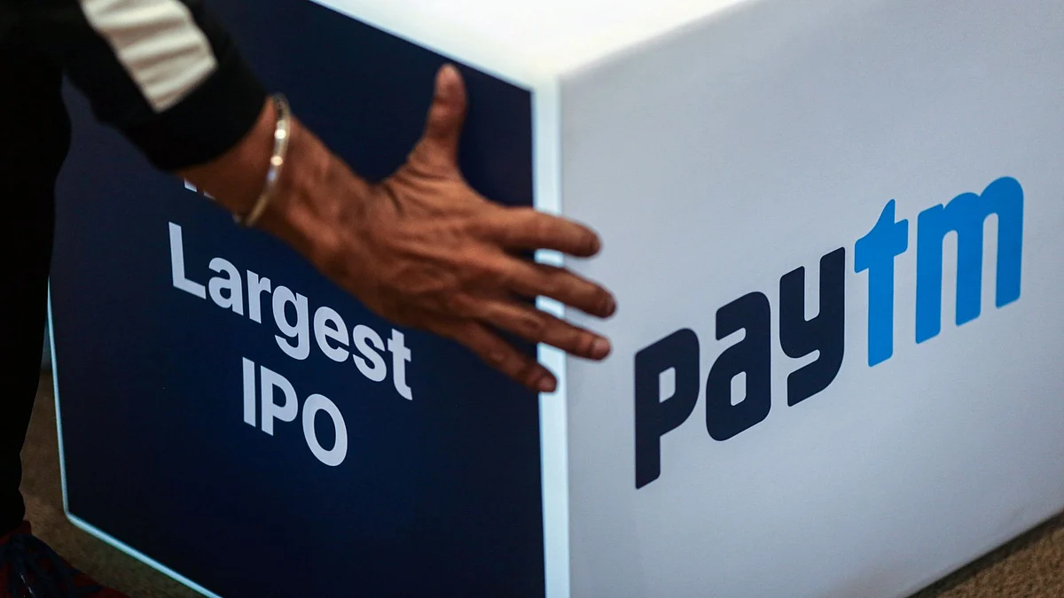 A worker prepares the stage during the listing ceremony for the IPO of One97 Communications Ltd., operator of PayTM, at the Bombay Stock Exchange in Mumbai, India, on Thursday, Nov. 18, 2021. One 97 Communications Ltd., which operates India's pioneering digital-payments brand Paytm, fell in its trading debut in Mumbai as investors questioned the company's valuations and path to profitability. Photographer: Dhiraj Singh/Bloomberg