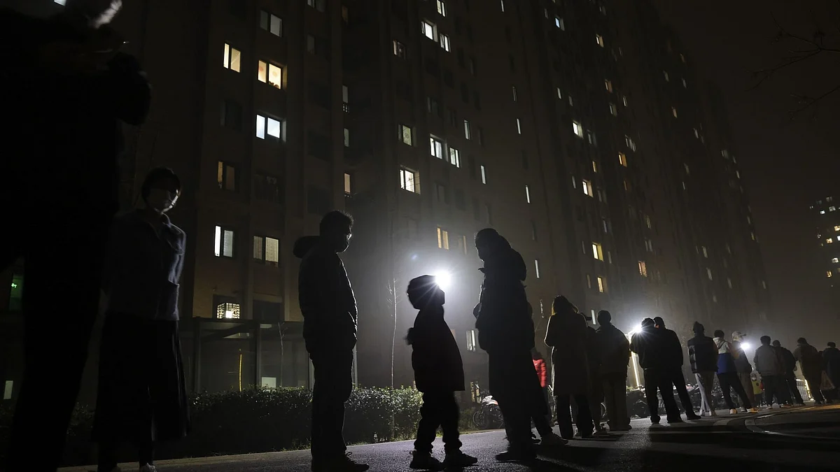 People wait in line at night for a swab test at a COVID-19 testing site in Beijing on November 20. Photographer: Lintao Zhang/Getty Images