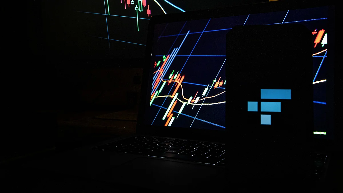 The FTX logo on a smartphone alongside trading graphs arranged in Barcelona, Spain, on Tuesday, Nov. 15, 2022. FTX Group named a slate of new independent directors to oversee the collapsed crypto empire and said its bankruptcy may involve more than a million creditors. Photographer: Angel Garcia/Bloomberg