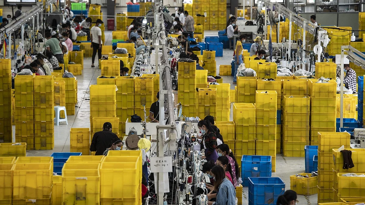 Workers on the production line at a facility at the Ruili Industrial Park in Ruili, Yunnan province, China. Photographer: Qilai Shen/Bloomberg
