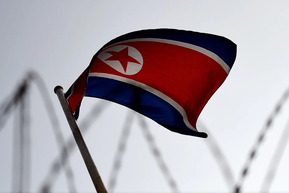 The North Korean flag is seen flying in backdrop of barbed wire at the North Korean embassy in Kuala Lumpur. Photographer: Manan Vatsyayana/Getty Images