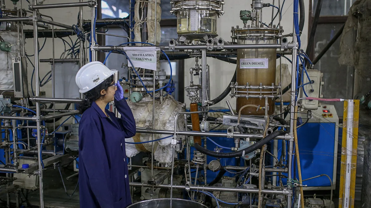 A worker observes the bio jet fuel production at Council Of Scientific And Industrial Research, Indian Institute of Petroleum in Dehradun, India, on Friday, Oct. 7, 2022.