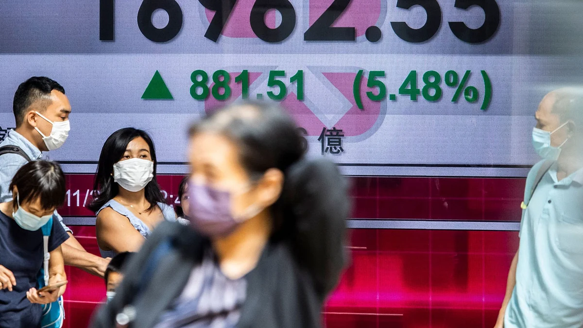 Screen showing stock figures in Hong Kong. Photographer: Isaac Lawrence/AFP/Getty Images