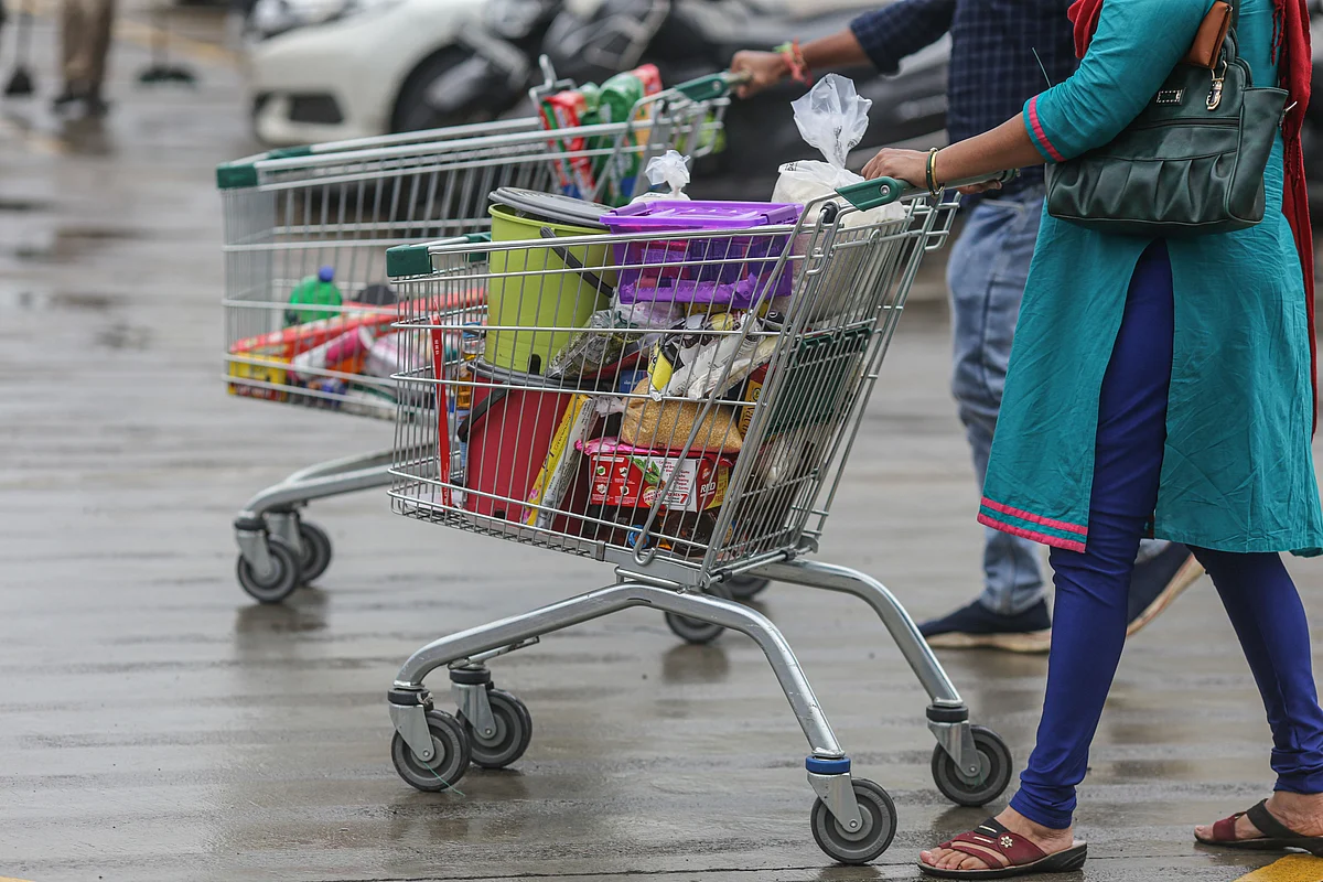 Shoppers push shopping carts in the parking lot at a DMart store operated by Avenue Supermarts Ltd., in Mumbai, India, on Tuesday, Aug. 16, 2022. The company opened its highest-ever 50 stores in the year through March, its most ever, and wants to tap Indias teeming middle-class, which according to some researchers could account for as much as half of countrys almost 1.4 billion population. Photographer: Dhiraj Singh/Bloomberg