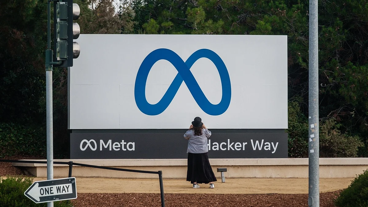<div class="paragraphs"><p>A visitor takes photographs of Meta Platforms signage outside the company's headquarters in Menlo Park, California, U.S.</p></div>