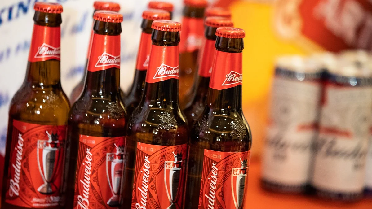Budweiser beer products, produced by Anheuser-Busch InBev NV, sit displayed during a news conference in Hong Kong, China, on Tuesday, Sept. 17, 2019. Anheuser-Busch InBev NV is reviving the Hong Kong initial public offering of its Asian unit and is set to raise as much as $4.8 billion, roughly half of an earlier target. Photographer: Kyle Lam/Bloomberg