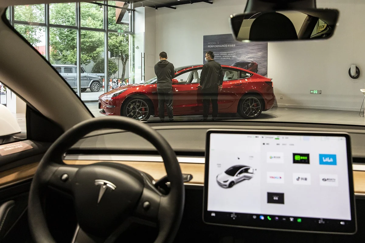 Customers at a Tesla Inc. showroom in Shanghai, China, on Sunday, Oct. 16, 2022. Tesla is scheduled to release third-quarter earnings results on Oct. 19. Photographer: Qilai Shen/Bloomberg