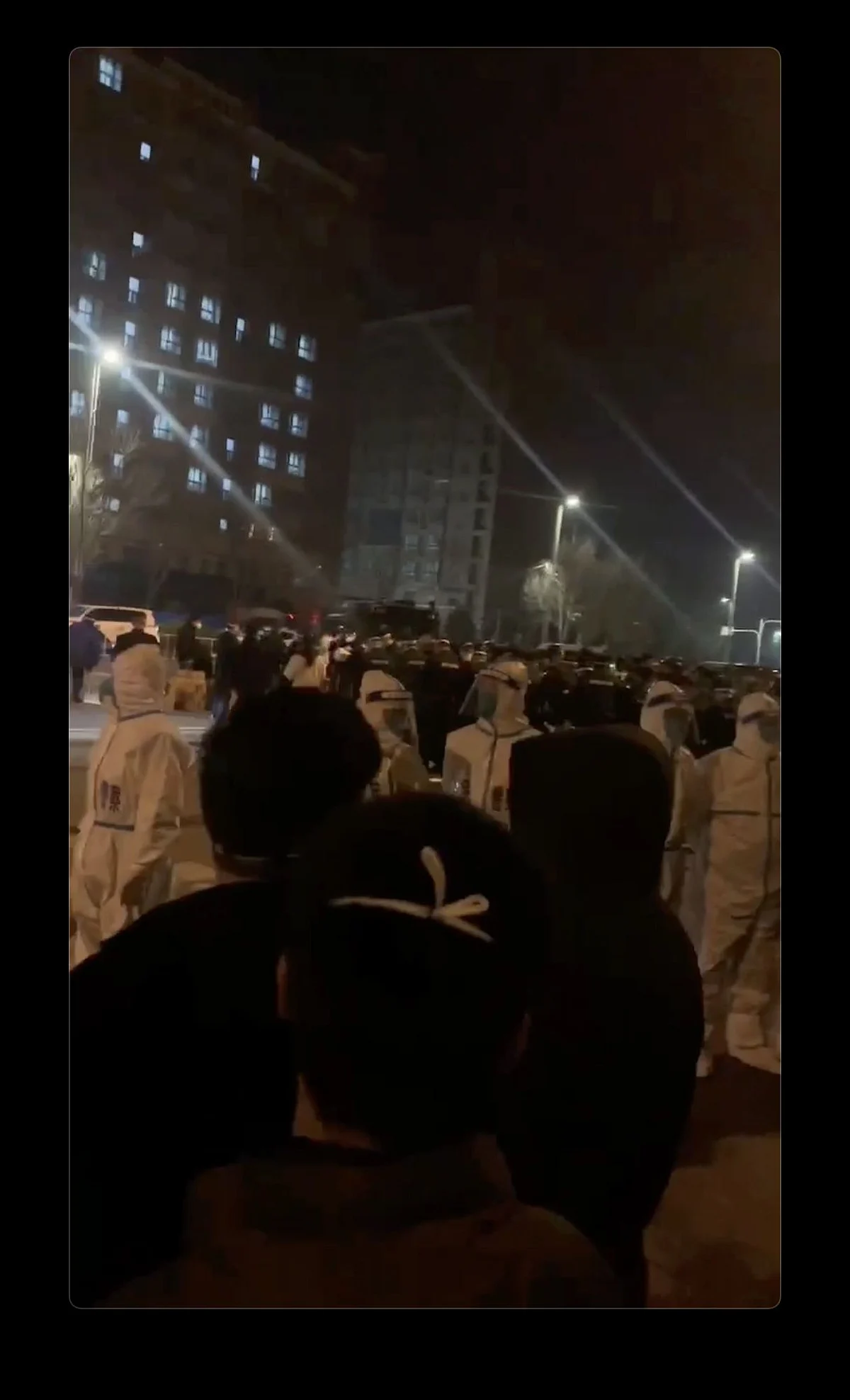 Screenshot from video of police officers outside the dormitory compound.