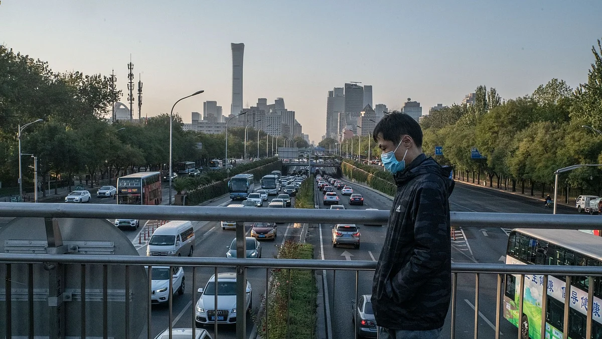 A pedestrian on a bridge in Beijing, China, on Monday, Oct. 24, 2022. China's yuan weakened and the country’s stocks tumbled in Hong Kong to the lowest level since the depths of the 2008 global financial crisis, a stark rebuke of President Xi Jinping's move to stack his leadership ranks with loyalists. Bloomberg