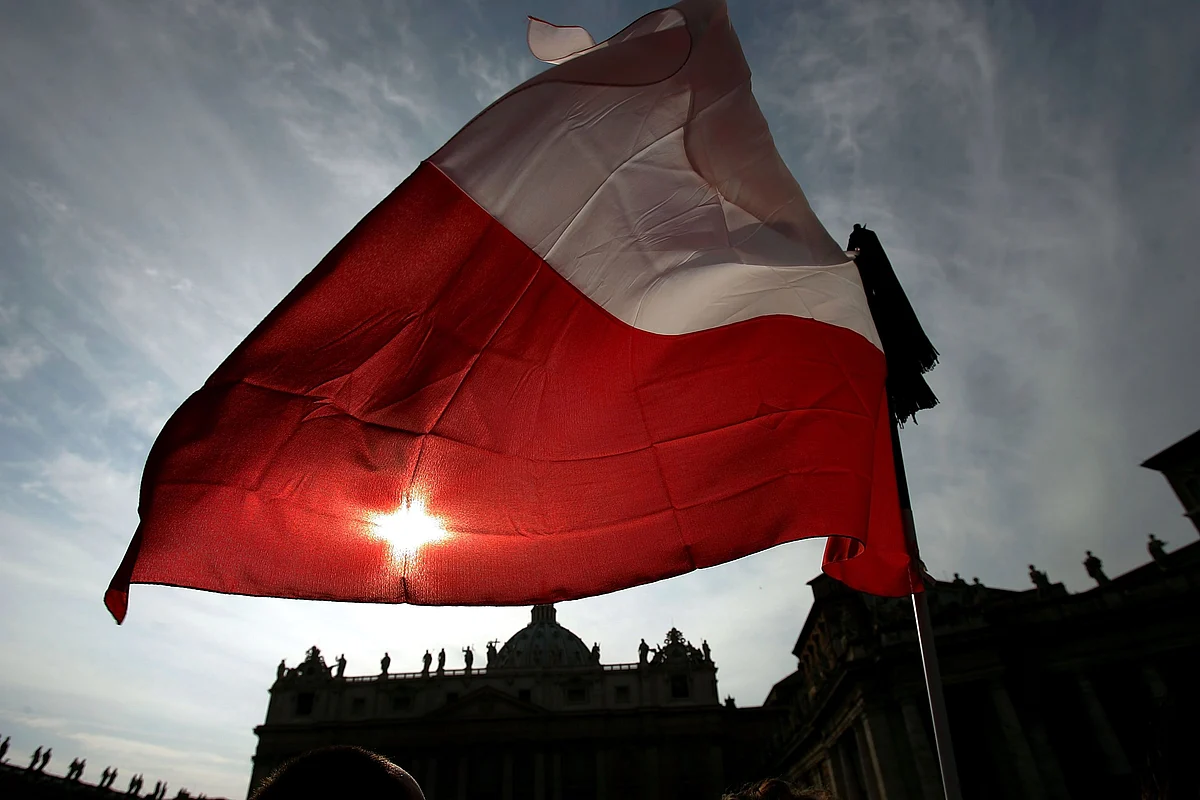 VATICAN CITY, VATICAN CITY - APRIL 03: The Polish flag flys over St Peter's Basilica where thousands of mourners continue to flock to pay tribute to departed Pope John Paul II April 3, 2005 in the Vatican City. Vatican officials continue to make plans for the Pope's funeral, when it is expected over one million catholics will attend. (Photo by Christopher Furlong/Getty Images)