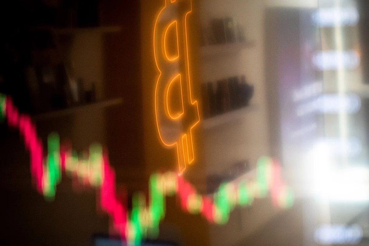 A reflection of a candlestick price chart and an illuminated Bitcoin logo inside a BitBase cryptocurrency exchange in Barcelona, Spain, on Monday, May 16, 2022. The wipeout of algorithmic stablecoin TerraUSD and its sister token Luna knocked more than $270 billion off the crypto sector’s total trillion-dollar value in the most volatile week for Bitcoin trading in at least two years. Photographer: Angel Garcia/Bloomberg