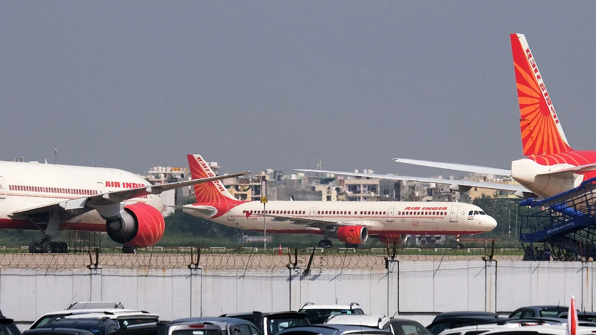 An Air India Ltd. aircraft taxis past other aircraft operated by the airline at the Indira Gandhi International Airport in New Delhi, India, on Tuesday, Sept. 28 2021. The India government is attempting to sell state-run Air India after two failed attempts. Despite the mounting debt and losses, the airline has some lucrative assets, including valued slots at London's Heathrow airport, a fleet of more than 100 planes and thousands of trained pilots and crew.