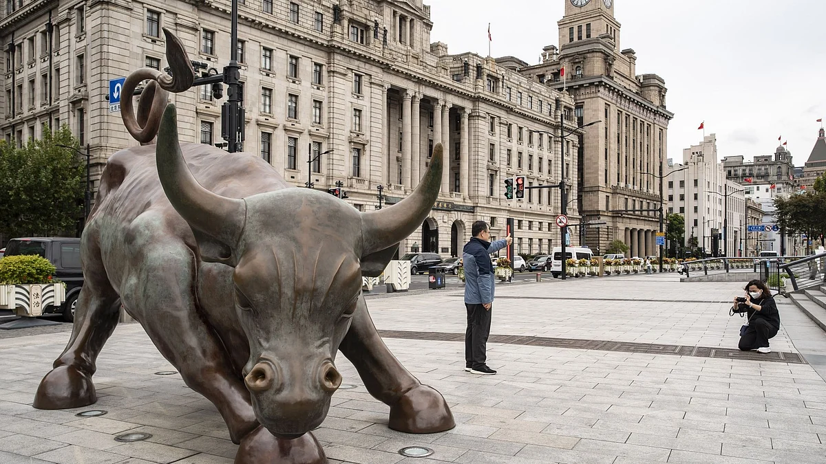 The Bund Bull statue in Shanghai, China, on Wednesday, Oct. 26, 2022. China’s economy slowed in October as car and real-estate sales weakened and global trade and small business confidence contracted, signaling last month’s pickup in activity wasn’t enough to change the country’s grim economic picture. Photographer: Qilai Shen/Bloomberg