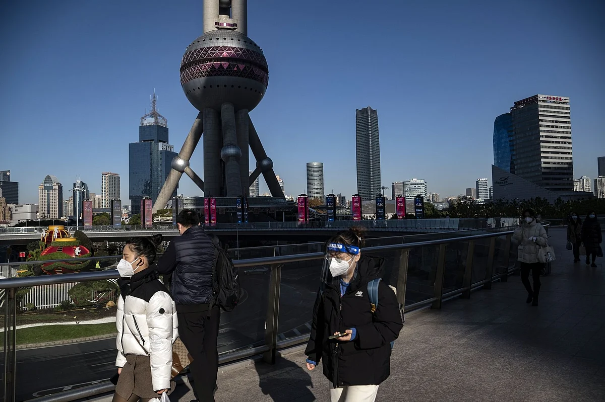 Pedestrians in the Lujiazui Financial District in Shanghai, China, on Tuesday, Dec. 20, 2022. China appears to be seeing an increase in Covid deaths across a swath of the country that aren’t being reported in government figures, according to social media posts, adding to speculation that officials are masking the full impact of their abrupt shift away from Covid Zero. Photographer: Qilai Shen/Bloomberg