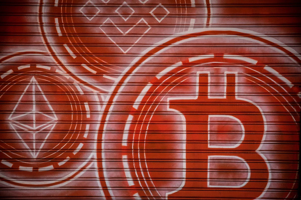Logos for Binance Coin, top, Ether, left, and Bitcoin inside a cryptocurrency exchange in Barcelona, Spain, on Wednesday, March 9, 2022. Bitcoin dropped back below $40,000, erasing almost all the gains sparked by optimism about U.S. President Joe Biden’s executive order to put more focus on the crypto sector. Photographer: Angel Garcia/Bloomberg