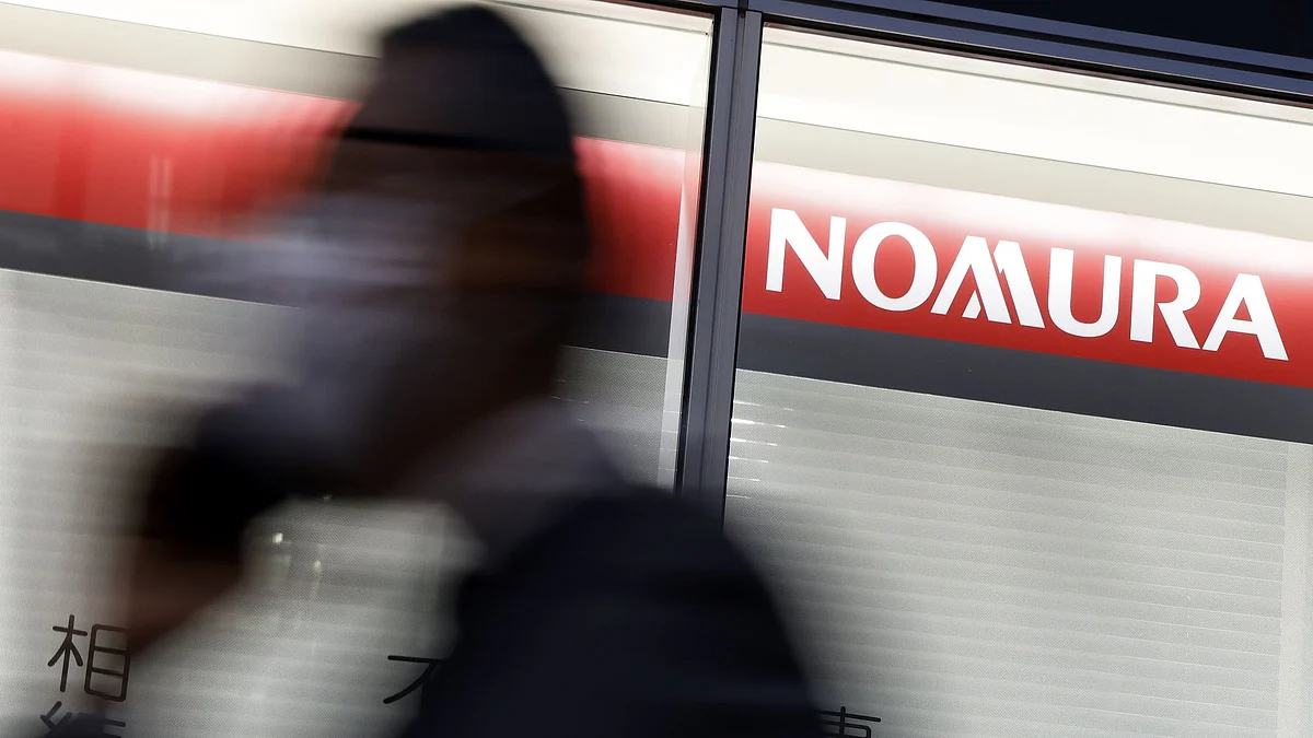 Signage for Nomura Holdings Inc. outside a Nomura Securities Co. branch at dusk in Tokyo, Japan, on Monday, April 25, 2022. Nomura Holdings is scheduled to release earnings figures on April 25. Photographer: Kiyoshi Ota/Bloomberg