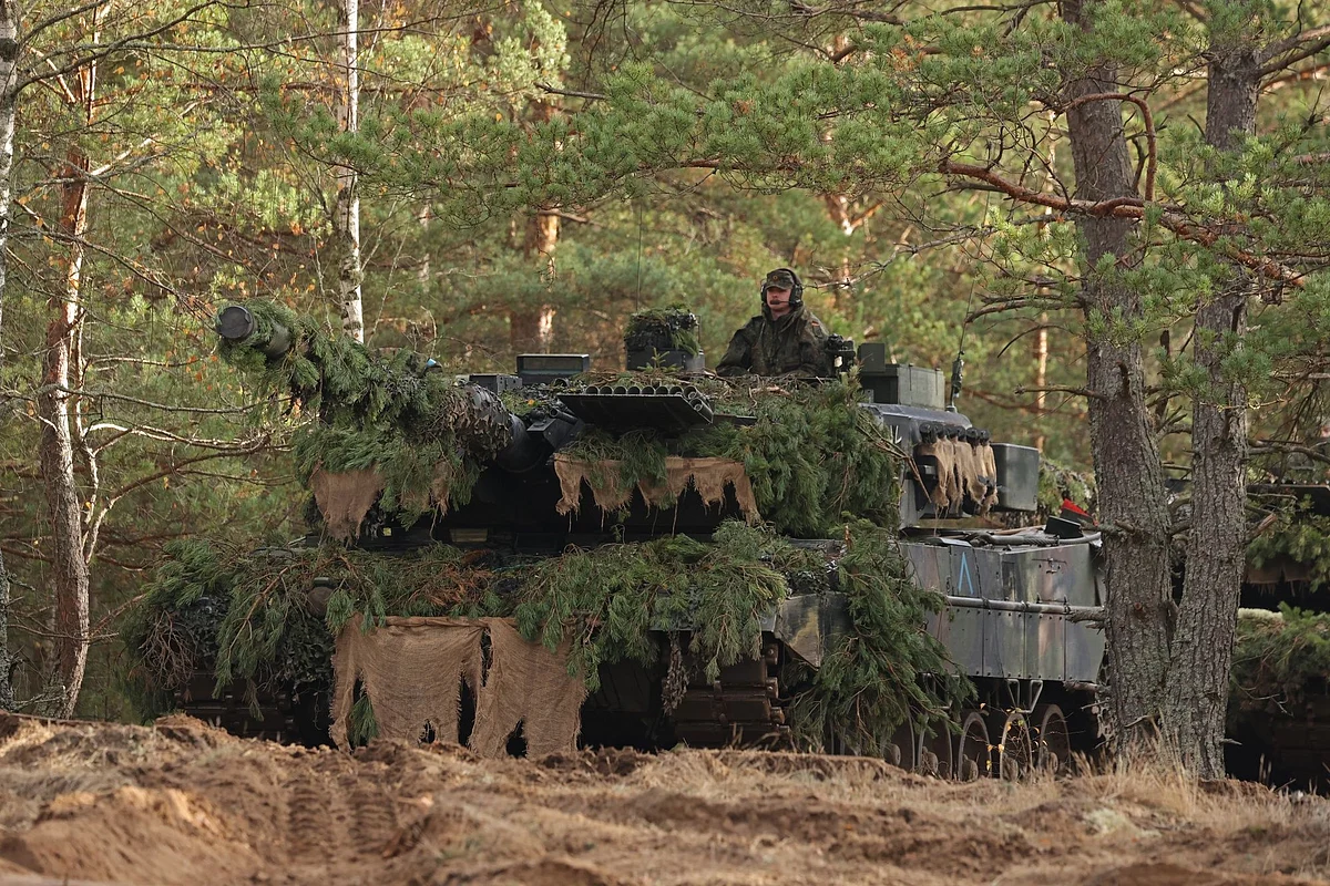PABRADE, LITHUANIA - OCTOBER 26: A Leopard 2A6 main battle tank of the Bundeswehr, the German armed forces, participates in the NATO Iron Wolf military exercises on October 26, 2022 in Pabrade, Lithuania. Germany leads a NATO contingent of troops in Lithuania under the Enhanced Forward Presence (eFP) battle group, with troops also from Belgium, the Czech Republic, the Netherlands, Luxembourg and Norway. (Photo by Sean Gallup/Getty Images) Photographer: Sean Gallup/Getty Images Europe