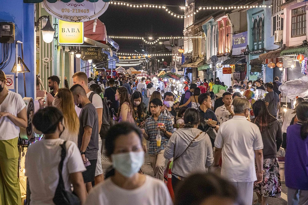 Tourists and locals browse goods and food at a walking street market in Phuket, Thailand, on Sunday, Oct. 2, 2022. Thailand will end a nationwide state of emergency declared in the wake of Covid outbreak after the Southeast Asian nation downgraded the virus from a “dangerous” communicable disease to one that only requires surveillance.