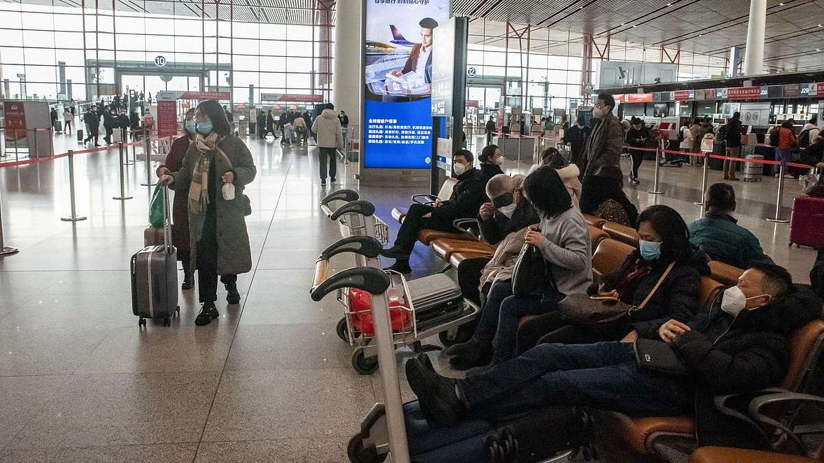 Travelers at Beijing Capital International Airport in Beijing, China, on Saturday, Jan. 14, 2023. There are growing concerns that this month’s Lunar New Year holiday will see Covid sweep through smaller cities and rural areas as hundreds of thousands of people travel home, with many finally able to reunite with family after three years. Bloomberg