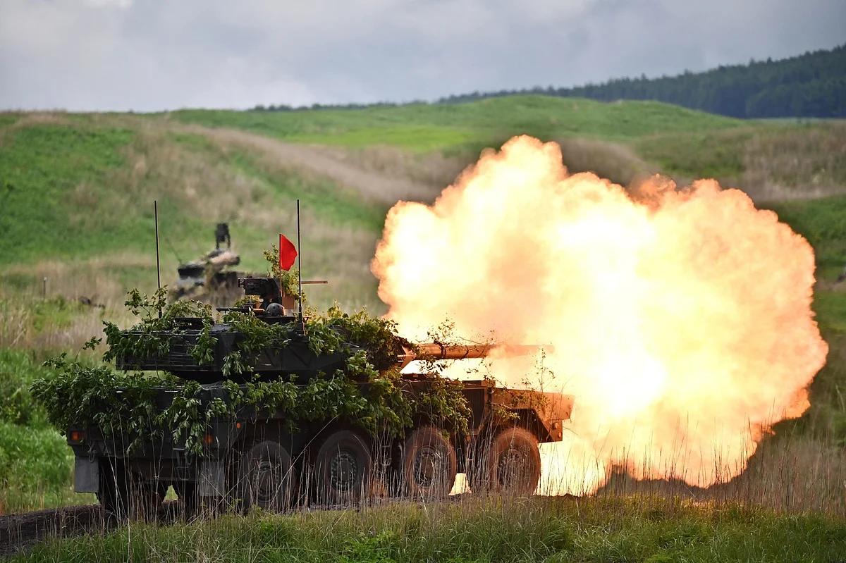 A Japan's Ground Self-Defense Forces (JGSDF) Type 16 maneuver combat vehicle fires ammunition during a live fire exercise at JGSDF's training grounds in the East Fuji Maneuver Area in Gotemba, Japan, on Saturday, May 23, 2020. Photographer: Charly Triballeau/AFP/Getty Images