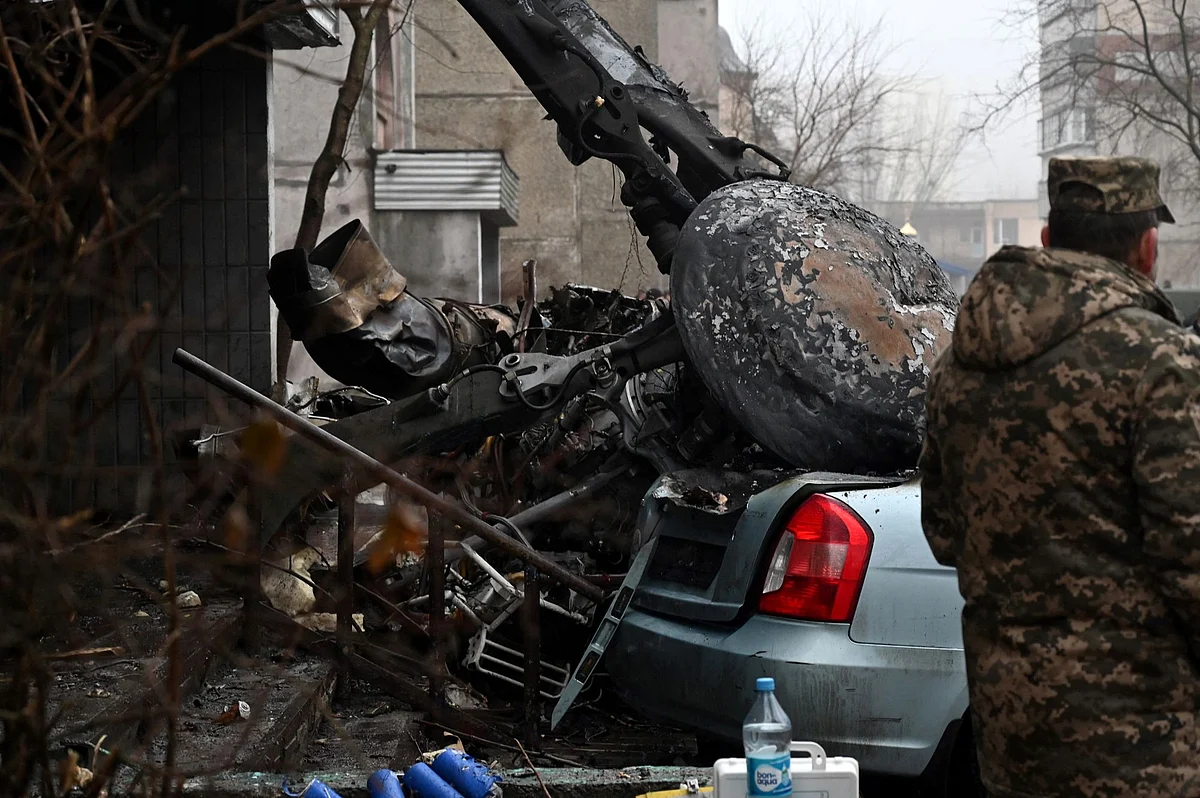 Security personnel attend the scene of a helicopter crash in Brovary, near Kyiv on Jan. 18. Photographer: Sergei Supinsky/Getty Images