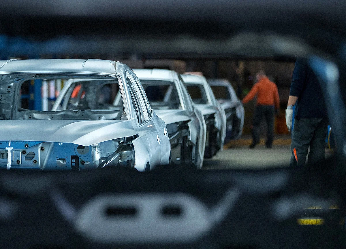 Unpainted Ford Focus automobile bodies stand on a quality check line inside the Ford Motor factory in Saarlouis, Germany.
