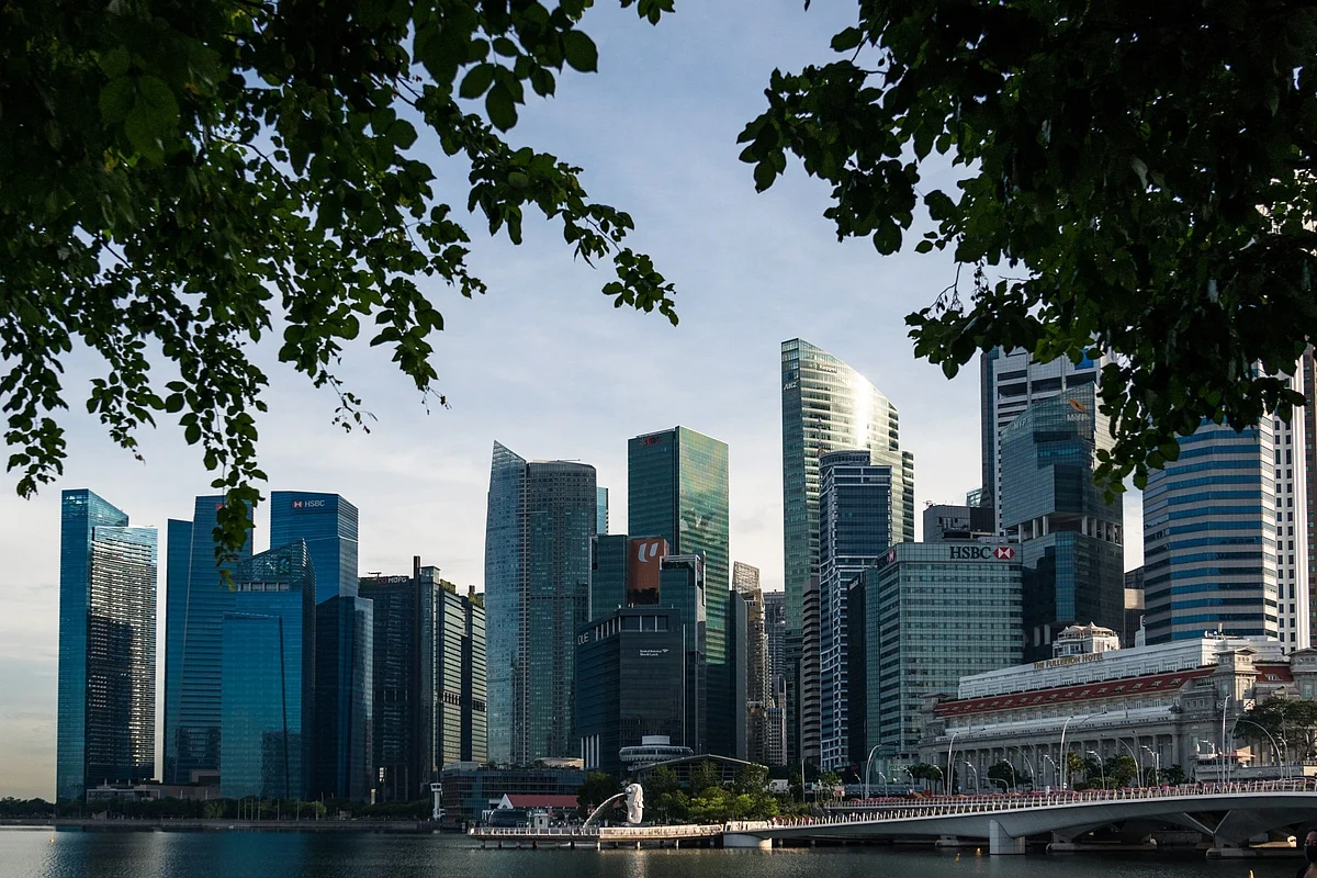 The Merlion Statue and Jubilee Bridge stand in front of the city skyline during the "circuit breaker" lockdown in Singapore, on Wednesday, May 20, 2020. Singapore will allow more businesses to reopen on June 2 -- increasing the active proportion of the economy to three-quarters -- after a nationwide lockdown cut transmission of the coronavirus among citizens and permanent residents.
