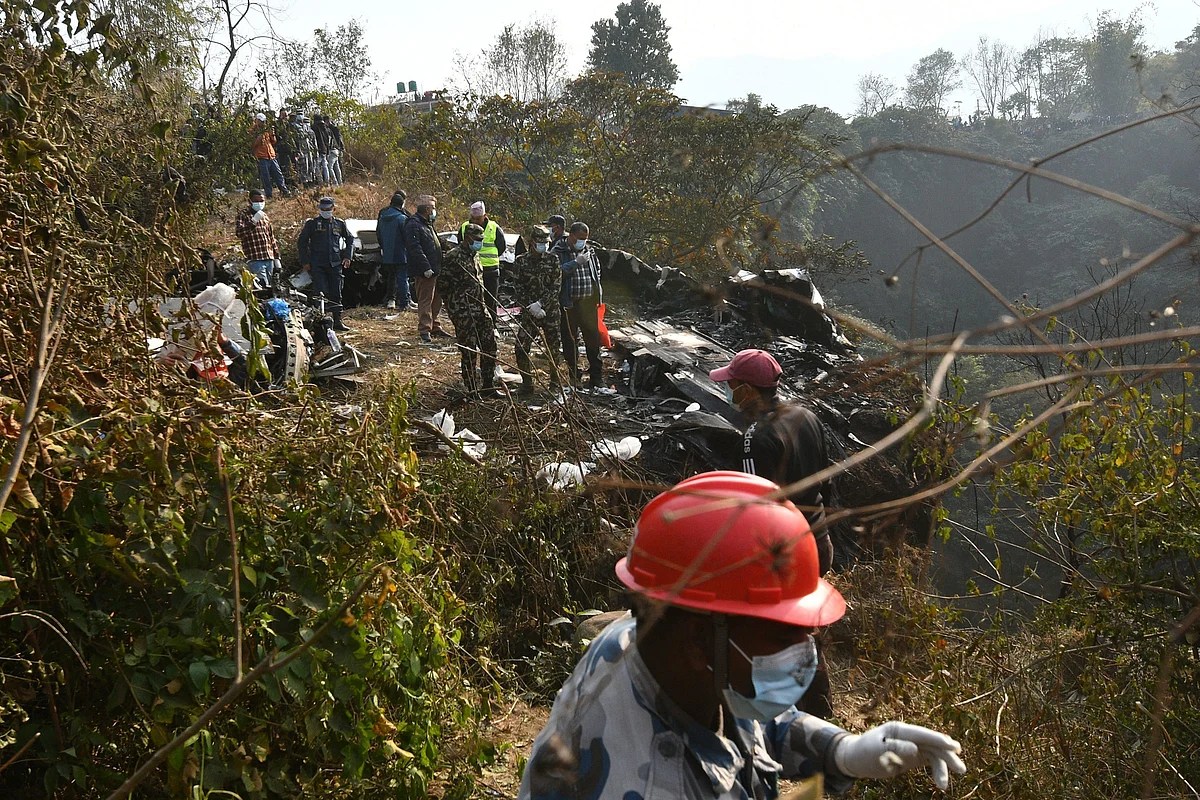 Rescuers at the site of a Yeti Airlines plane crash in Pokhara on Jan. 15. Photographer: Prakash Mathema/AFP/Getty Images