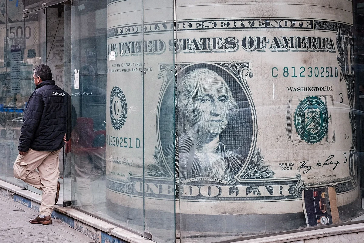 Images of US one dollar bills in the window of a currency exchange bureau in the Zamalek district of Cairo, Egypt, on Saturday, Jan. 7, 2023. Egypt’s urban inflation accelerated at its fastest pace in five years as several rounds of currency devaluation filtered through to consumers. Photographer: Islam Safwat/Bloomberg