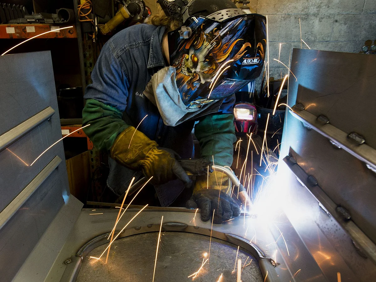 A worker uses a mig welder at a coal stove manufacturing facility in Berwick, Pennsylvania. Photographer: Ty Wright/Bloomberg
