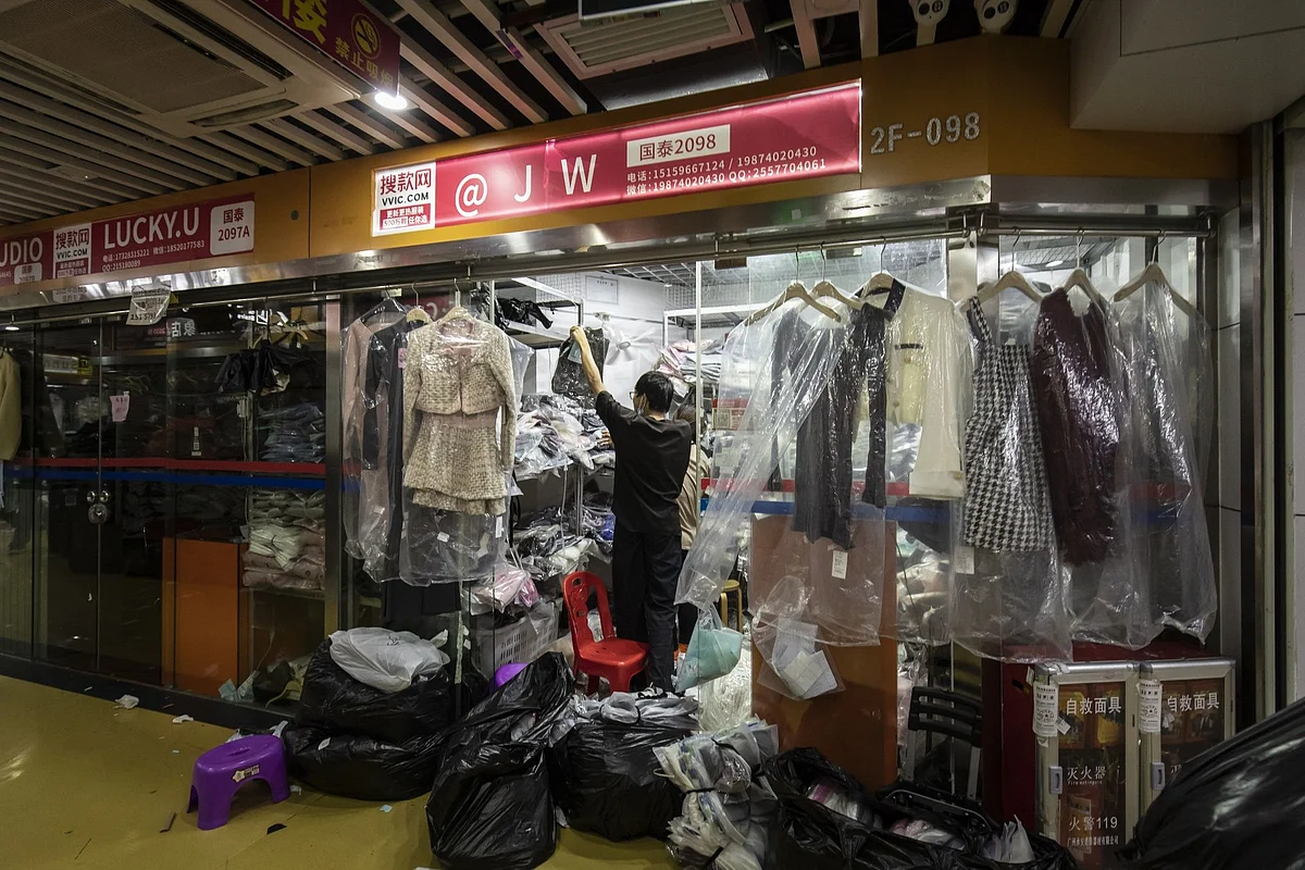 A worker at a garment mall at the Shahe textile and clothing wholesale market in Guangzhou, China, on Monday, Sept. 19, 2022. For decades, China's textile workforce has provided low-cost, quick-turnaround garments to global brands like H&M and Zara. Photographer: Qilai Shen/Bloomberg