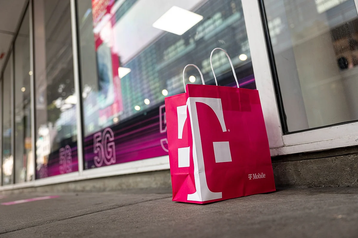 A T-Mobile branded shopping bag in front of a store in San Francisco, California, U.S., on Tuesday, March 16, 2021. T-Mobile US Inc. is kicking off a bond sale to help finance the purchase of new high-speed spectrum licenses as carriers roll out the next generation of mobile devices.