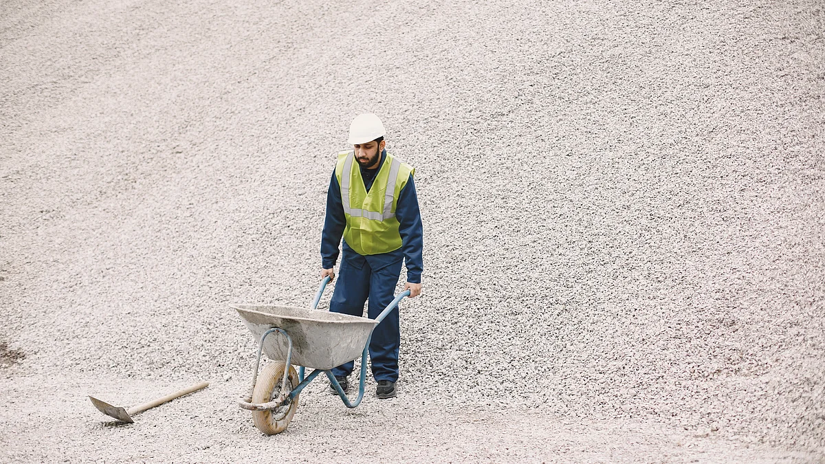 <div class="paragraphs"><p>A worker transports cement in a wheel-barrow. (Source: freepik)</p></div>