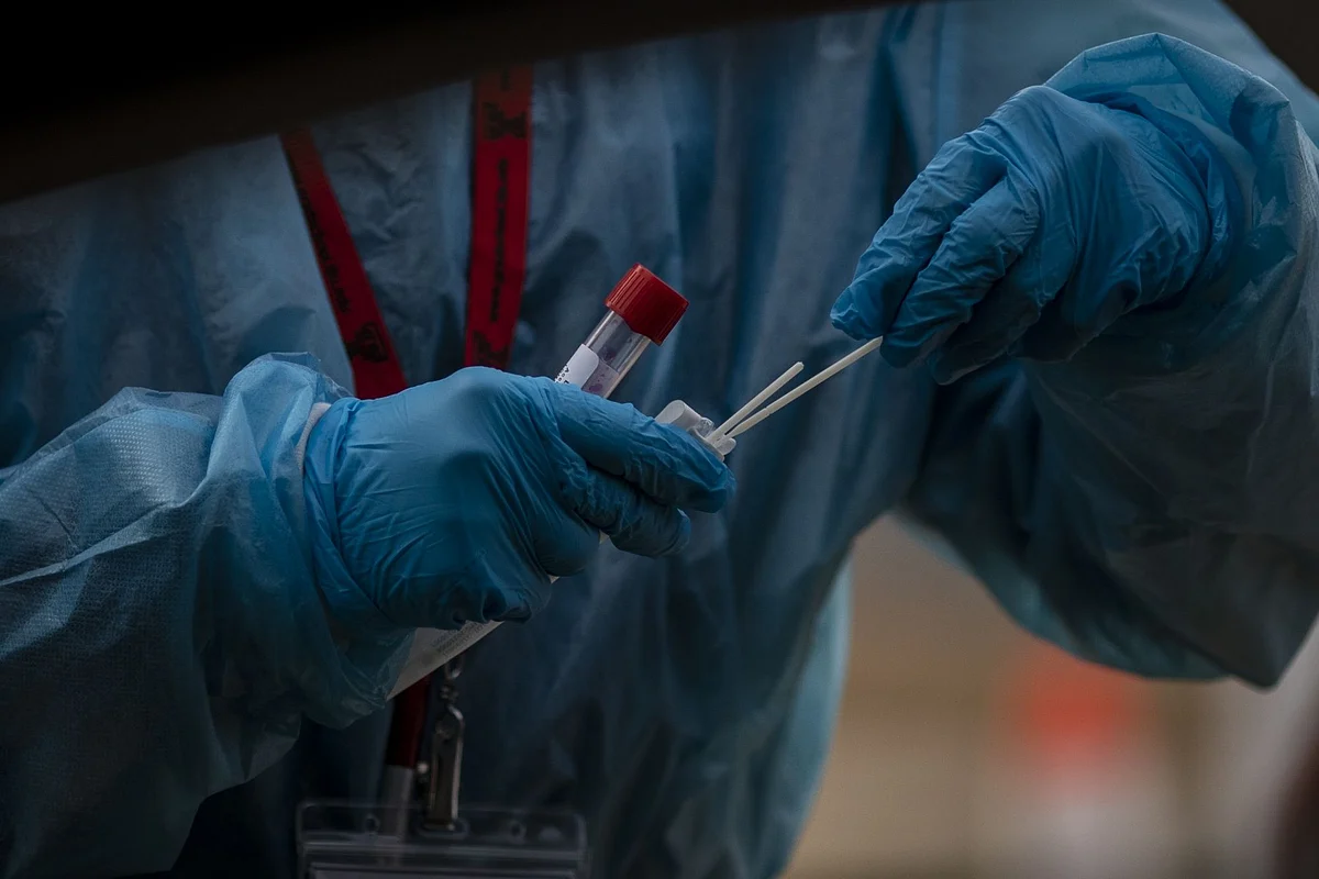 A healthcare worker prepares a Covid-19 swab test at the Boulder County Fairgrounds testing site in Longmont, Colorado, U.S., on Tuesday, Dec. 14, 2021. The omicron variant now makes up 3% of all sequenced Covid-19 cases in the U.S., rising from less than 0.1% in early December, health officials said, a sign of the rapid spread of the new coronavirus version.