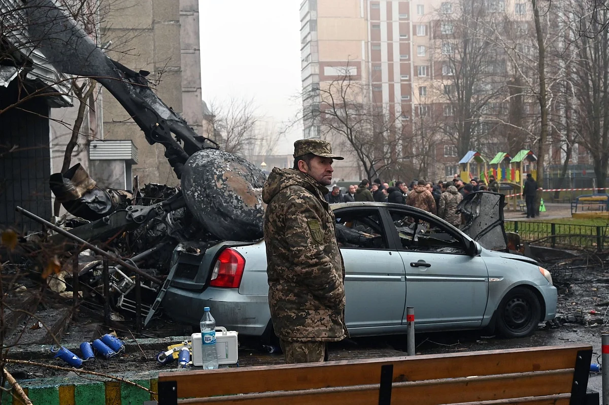 Security personnel attend the scene of a helicopter crash in Brovary, near Kyiv on Jan. 18. Photographer: Sergei Supinsky/AFP/Getty Images