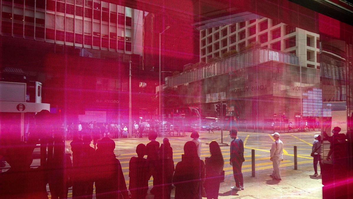 Pedestrians reflected in an electronic screen displaying stock figures in Hong Kong, China, on Tuesday, March 15, 2022. Chinese stocks suffered another deep selloff on Tuesday as concerns about the country’s ties with Russia and persistent regulatory pressure sent shares on a downward spiral.