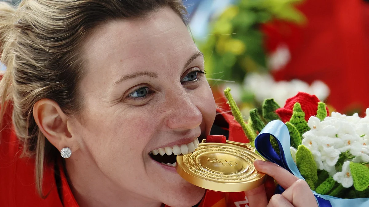 BEIJING, CHINA - FEBRUARY 17: Gold medal winner Laura Stacey #7 of Team Canada bites her gold medal after the Women's Ice Hockey Gold Medal match between Team Canada and Team United States on Day 13 of the Beijing 2022 Winter Olympic Games at Wukesong Sports Centre on February 17, 2022 in Beijing, China. (Photo by Bruce Bennett/Getty Images)