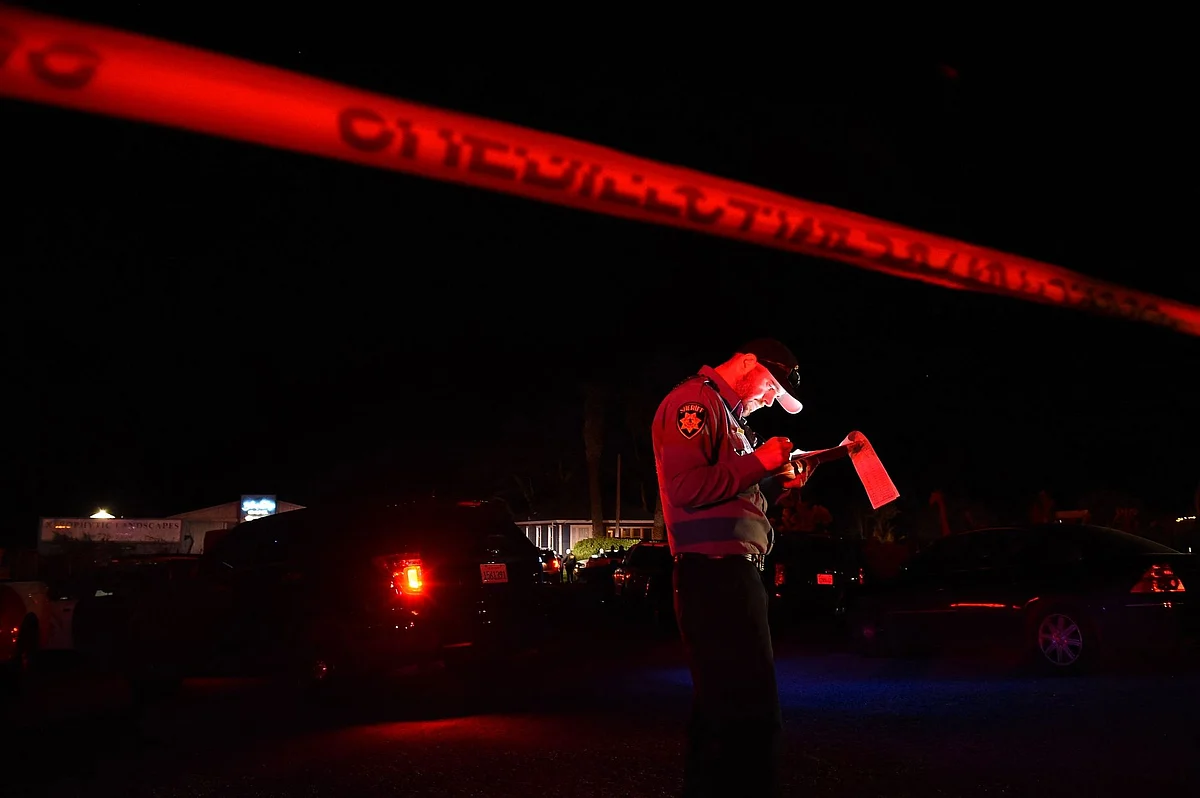 A San Mateo County sheriff deputy at the scene of a shooting on highway 92 in Half Moon Bay, California on January 23. Photographer: Susana Bates/AFP/Getty Images