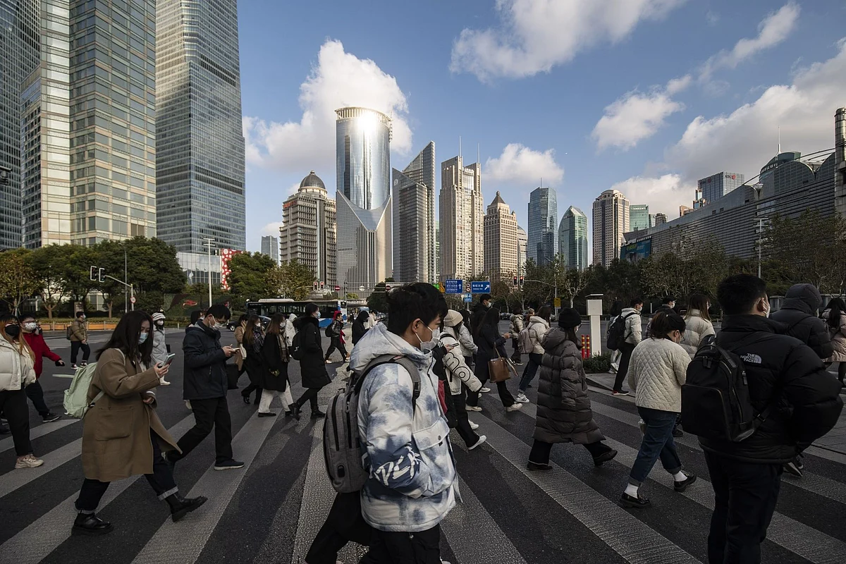 Pedestrians in Pudong's Lujiazui Financial District in Shanghai. Photographer: Qilai Shen/Bloomberg