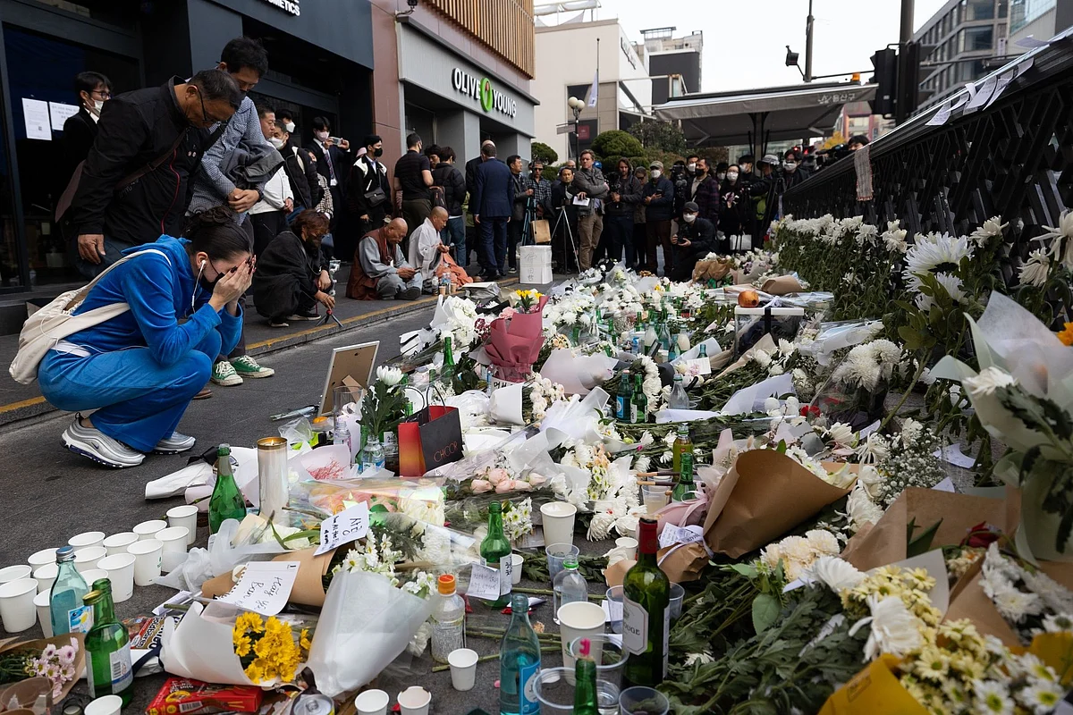 Mourners leave flowers near the site of a deadly crowd crush in the Itaewon district of Seoul, South Korea, on Monday, Oct. 31, 2022. The deadly surge of revelers in Seoul's Itaewon district on Saturday night hit citizens from at least 15 nations, prompting an outpouring of grief and offers of help from governments around the world.