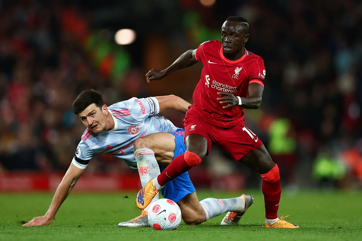 LIVERPOOL, ENGLAND - APRIL 19: Harry Maguire of Manchester United looks on as Sadio Mane of Liverpool runs with the ball during the Premier League match between Liverpool and Manchester United at Anfield on April 19, 2022 in Liverpool, England. (Photo by Clive Brunskill/Getty Images)