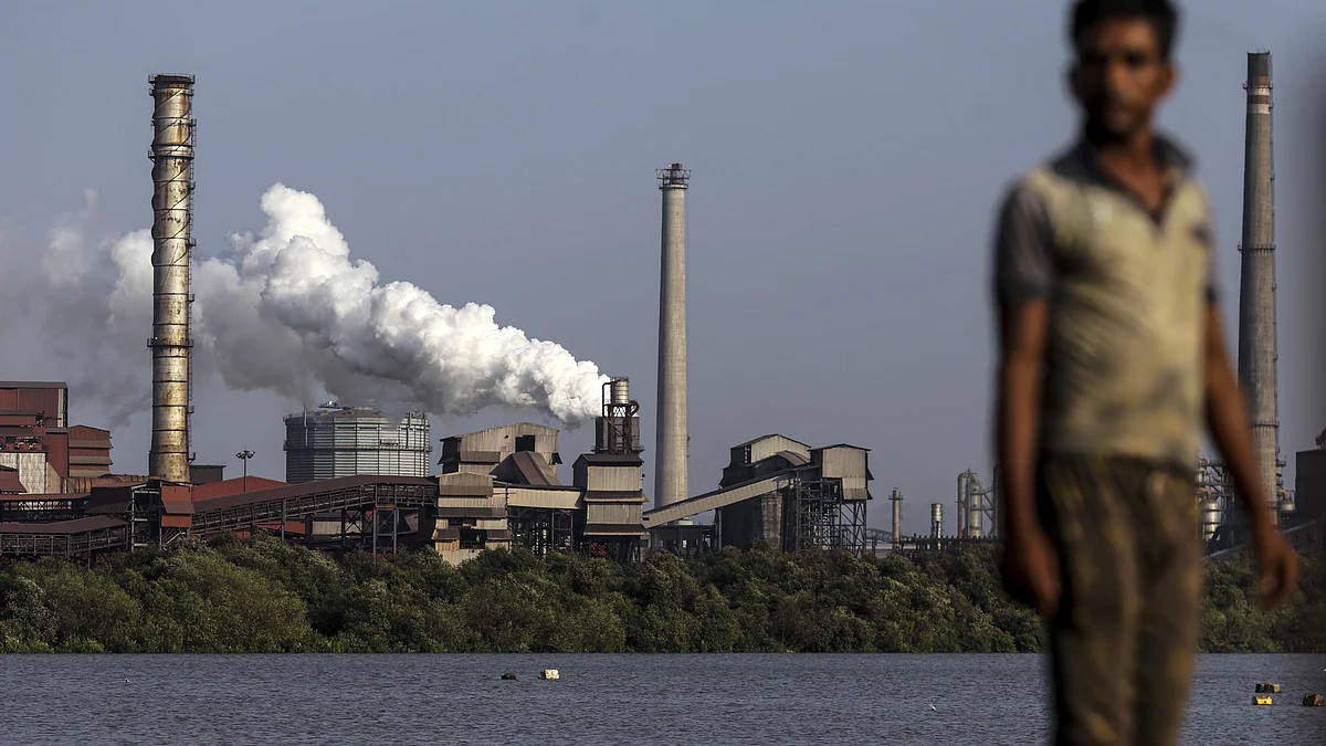 A laborer walks near the JSW Steel Ltd. manufacturing facility in Dolvi, Maharashtra, India, on Thursday, May 18, 2017. JSW, India's biggest producer, reported a jump in fourth-quarter profit, boosted by record output, and said it approved plans to raise about $2.5 billion in debt. Photographer: Dhiraj Singh/Bloomberg