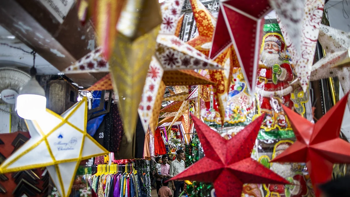 Customers walk past shops selling Christmas decoration goods in Panjim City, Goa, India, on Saturday, Dec. 17, 2022. India's retail inflation slowed below 6% for the first time in 2022 December, amid cooling global commodity prices and higher borrowing costs, providing reprieve for policymakers.