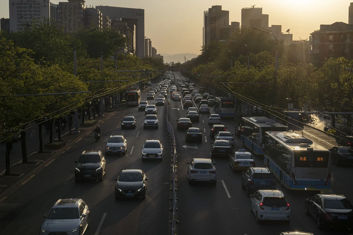 Traffic travel along a road in Beijing, China, on Thursday, April 23, 2020. China's economy will grow by less than 2% in 2020 as the anti-virus shutdowns combine with a collapse in global demand due to the pandemic, according to the latest Bloomberg survey of economists. Photographer: Giulia Marchi/Bloomberg