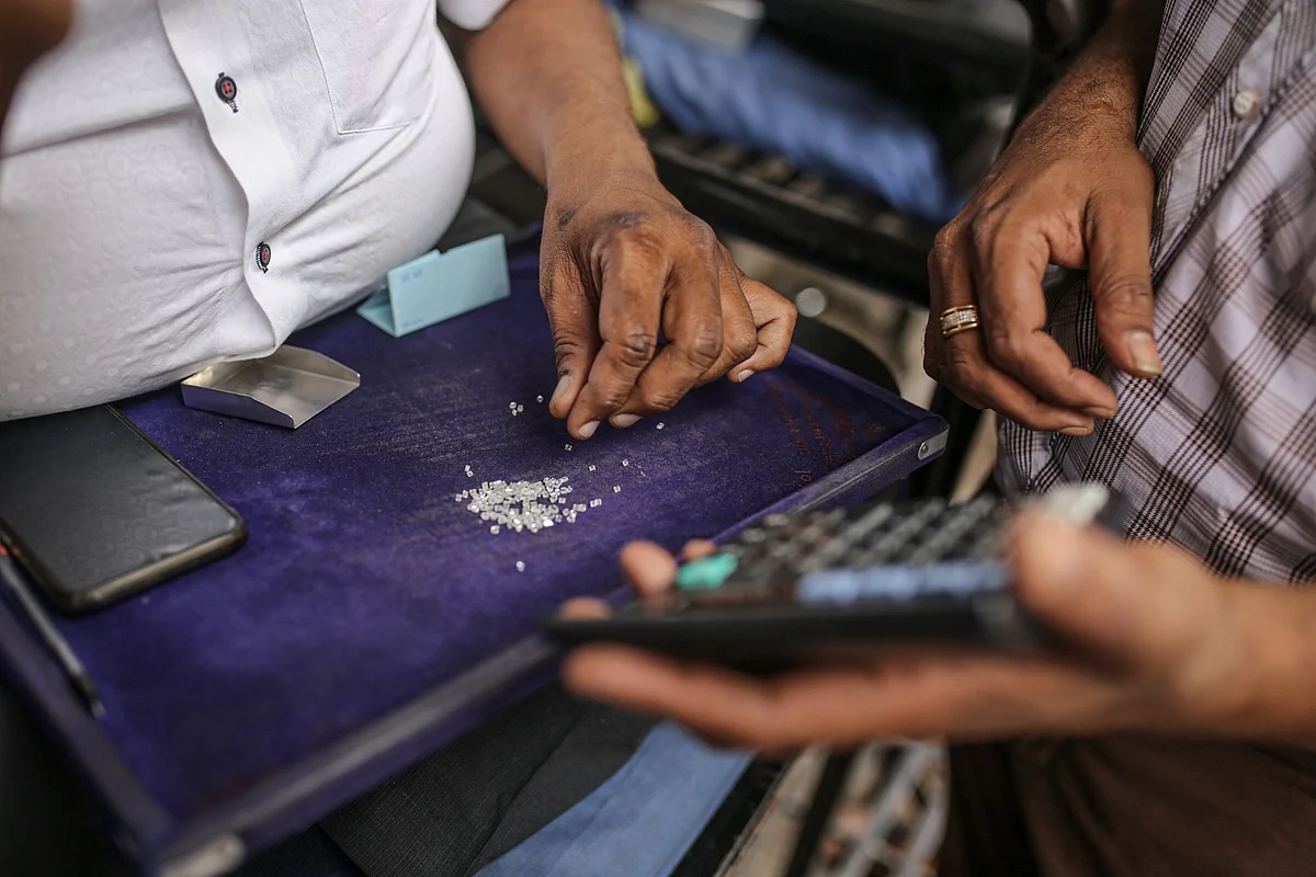 Traders inspect diamonds at a diamond market in Surat, Gujarat, India, on Tuesday, April 12, 2022. Russia’s invasion of Ukraine is fracturing a billion-dollar trade that spans the permafrost-laden diamond mines of Siberia, secretive trade houses in Antwerp, dusty polishing powerhouses in India and New York’s glittering designer jewelry stores.