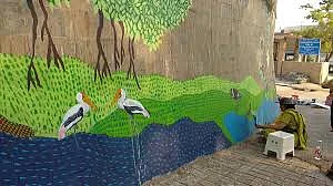 Abha lending a finishing touch to the people's painting at Dr Salim Ali Bird Sanctuary