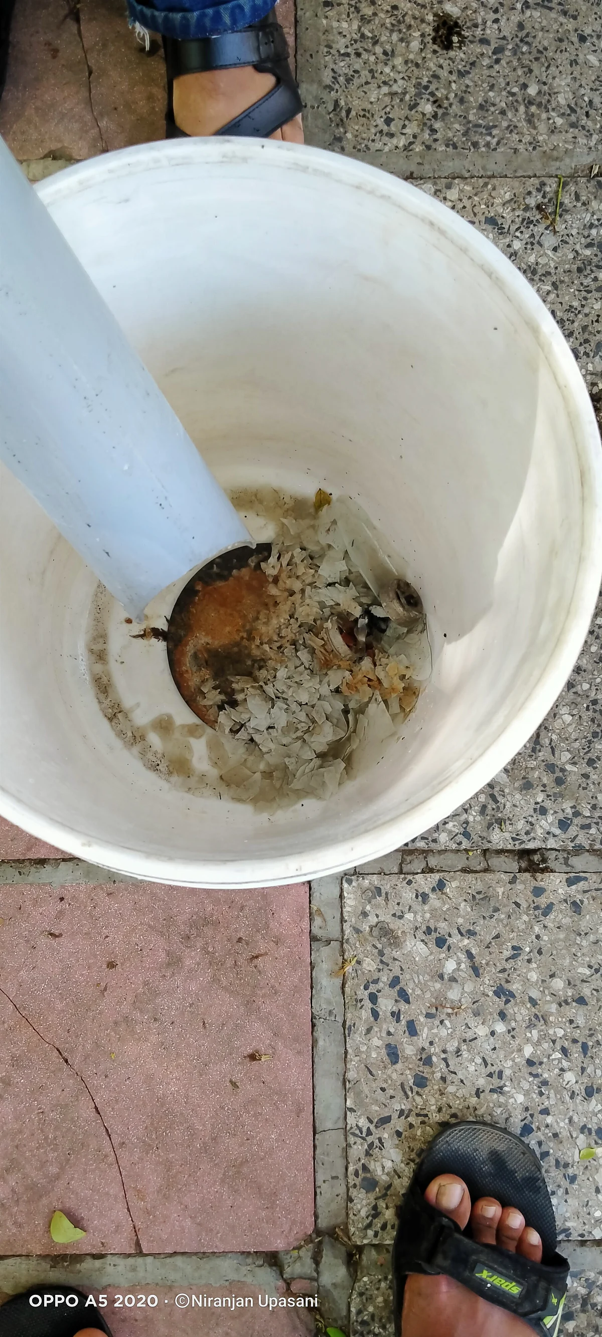 Crushed tubelight pieces at the bottom of the bucket