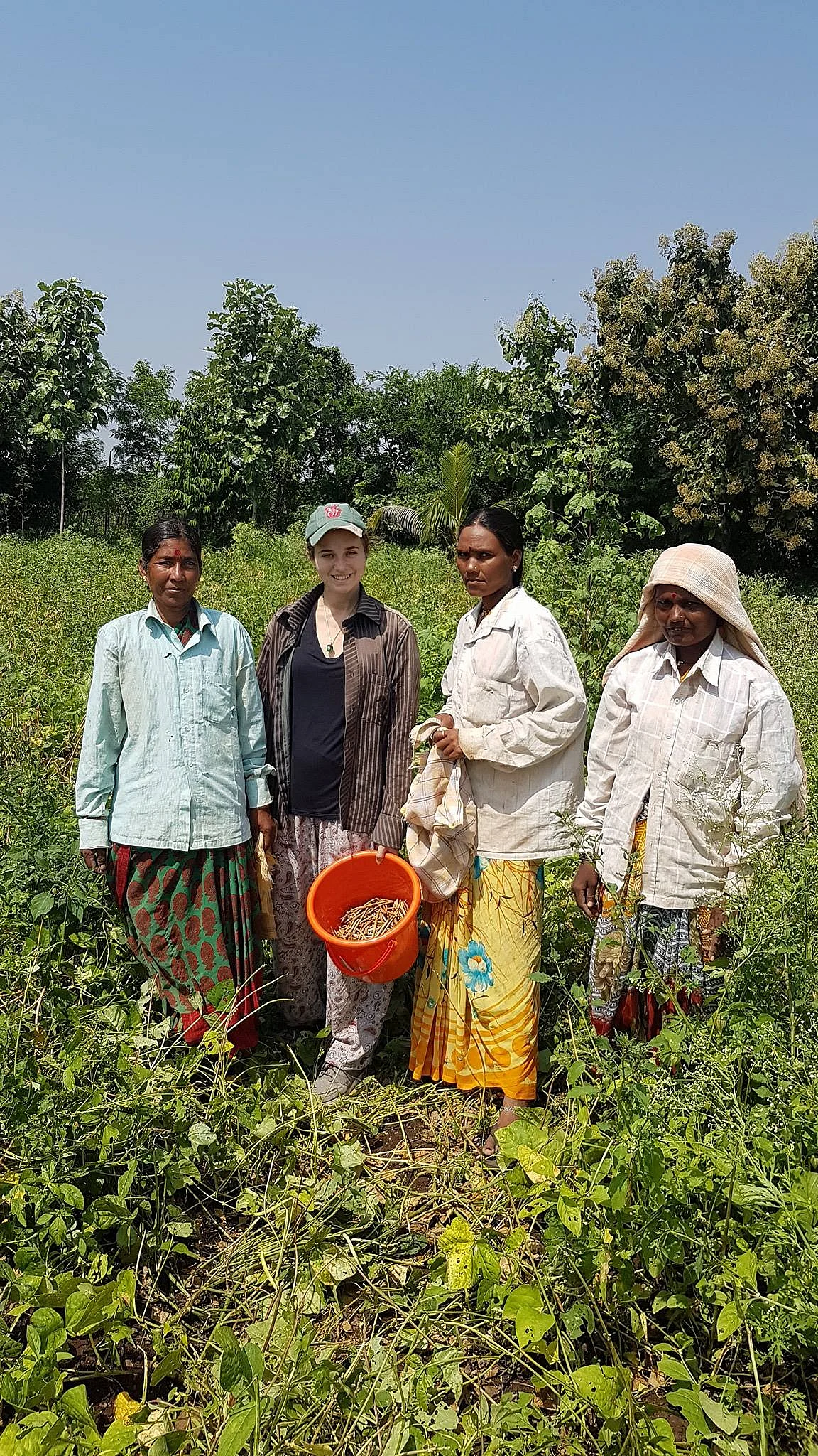 A lady from Europe at the farm with farm attendants, is one of many such who come to learn and help in farming activities