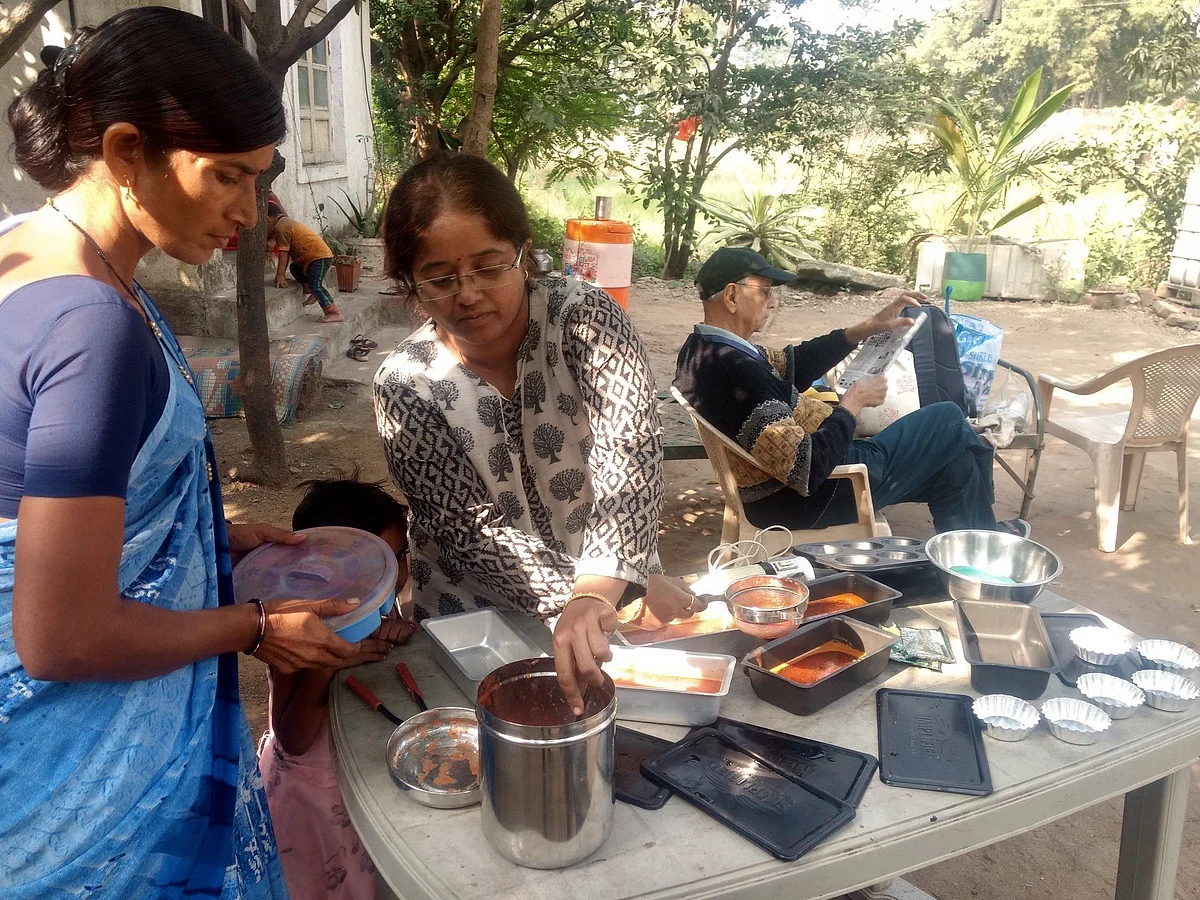 Packing the raw material into the solar cooker vessels