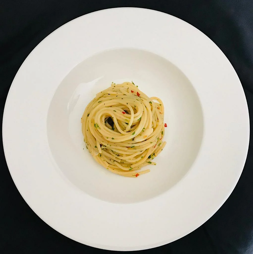 Spaghetti AOP: Classical Italian pasta cooked with garlic,chilly flakes and finished with extra virgin olive oil prepared by Chef Karan